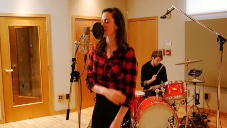 woman singing in recording studio