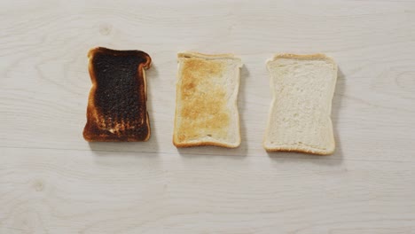 video of differently baked toasts seeing from above on wooden worktop