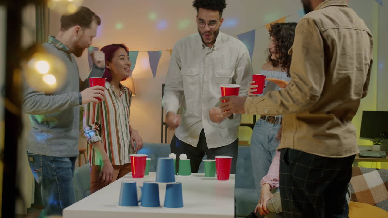 Friends Enjoying a Cup Stacking Party Game