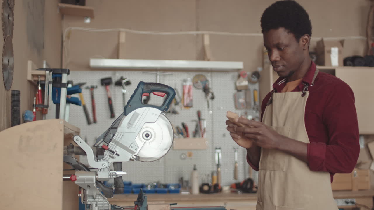 African American Joiner Using Circular Saw while Working