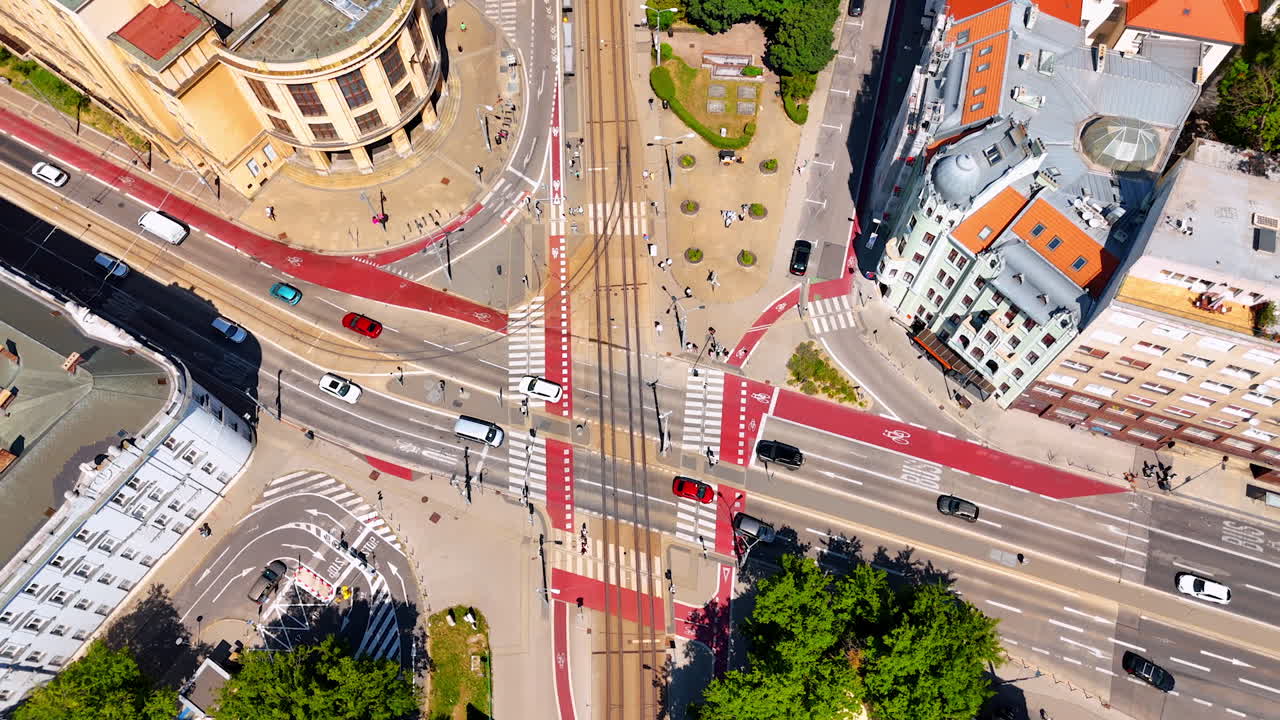 Transport moves by the roads in the modern city. Drone rising over the crossroads in the old town of Bratislava, Slovakia