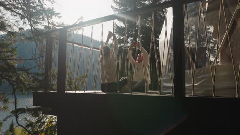 man and woman raise hands during meditation. woman and man participate in yoga session in serene environment. partners revel in harmony of connection