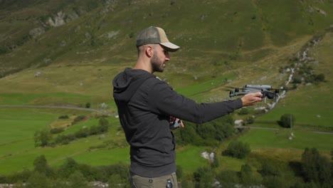 content creator launches drone from hand in mountainous terrain