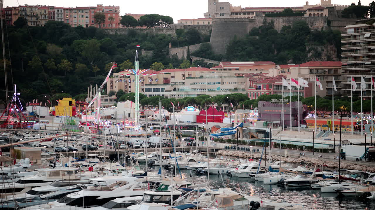 View of boats docked in the Monaco Marina with the skyline of the city on the background