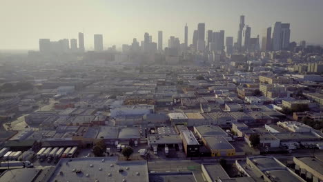 aerial view of los angeles industrial area with downtown skyline in hazy conditions