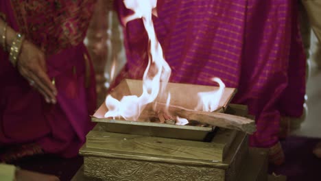 hindu wedding fire or grah shanti ceremony during hindu religious ceremony in india - close up