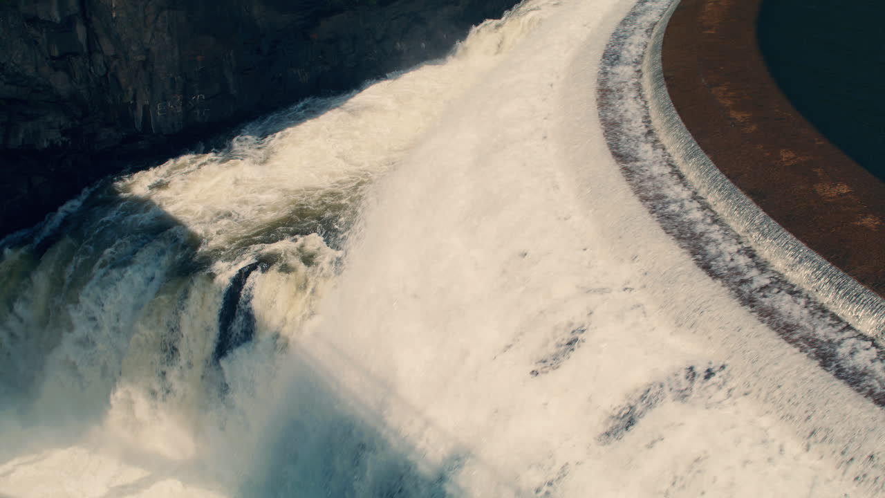 Closeup of White water rushing down New Croton Dam stepped spillway and gorge waterfall. Static shot, Slow motion 40 fps.