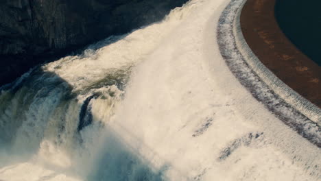 closeup of white water rushing down new croton dam stepped spillway and gorge waterfall. static shot, slow motion 40 fps.