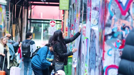 artists painting graffiti on melbourne's iconic street