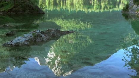 reflection in water of mountain lake. seamless loop