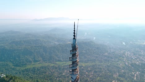experience the grandeur of ambuluwawa tower close to kandy city at sunrise, captured from a drone.