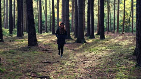 Girl-walks-in-the-forest-on-a-sunny-autumn-day