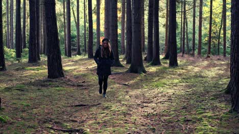 girl walks in the forest on a sunny autumn day