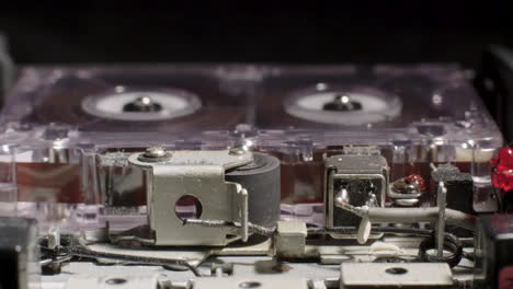 exposed internal components of microcassette recorder playing