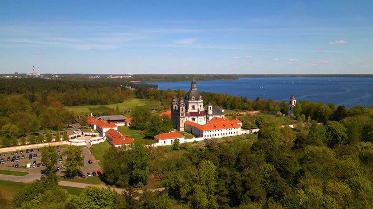 Aerial shot of old Pazaislis Monastery and Church on sunny day with blue clear sky, in Kaunas, Lithuania, zoom in shot