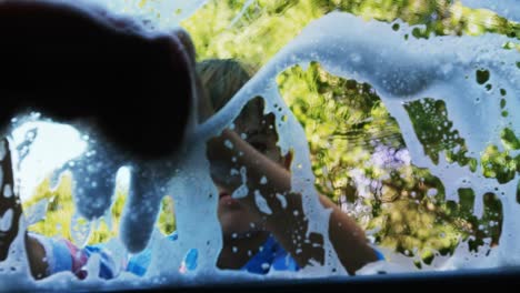 girl washing her car in the garden