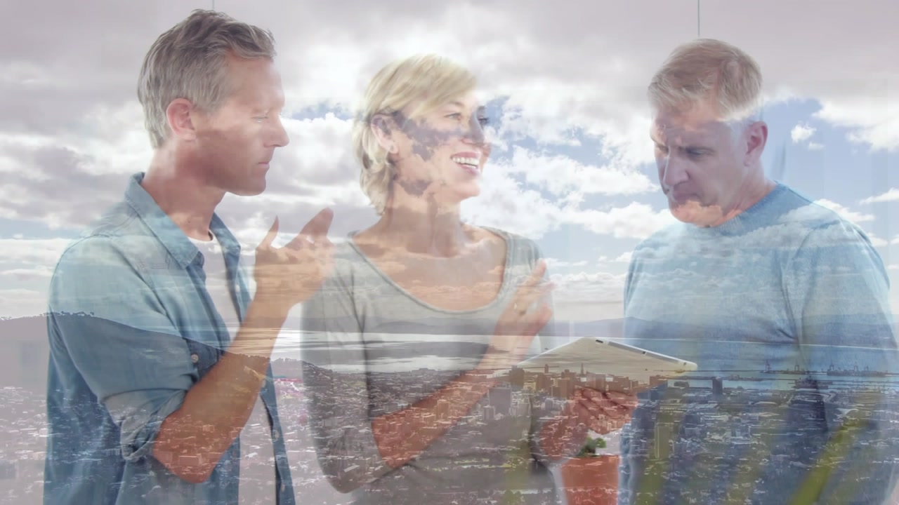 Animation of clouds over diverse business people using tablet