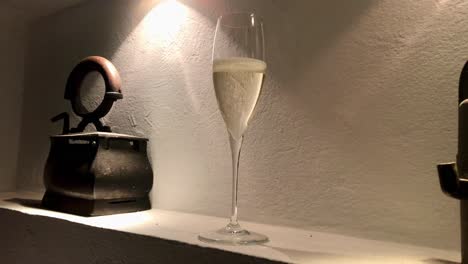 elegant display of sparkling champagne glass inside the cozy corner of wall shelf near rustic old iron