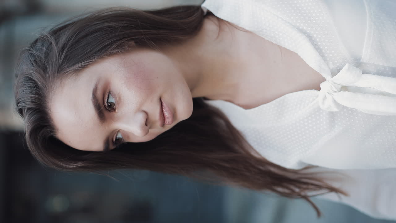 Portrait of a beautiful woman in a white shirt