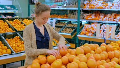 woman buying fresh grapefruits at grocery store