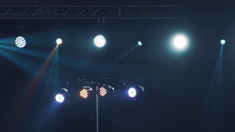 dark stage with colorful spotlights or several bright projectors.