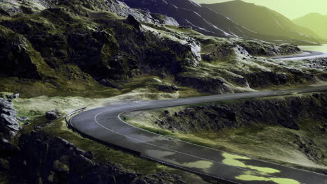 curvy mountain road winding through rocky landscape during sunset