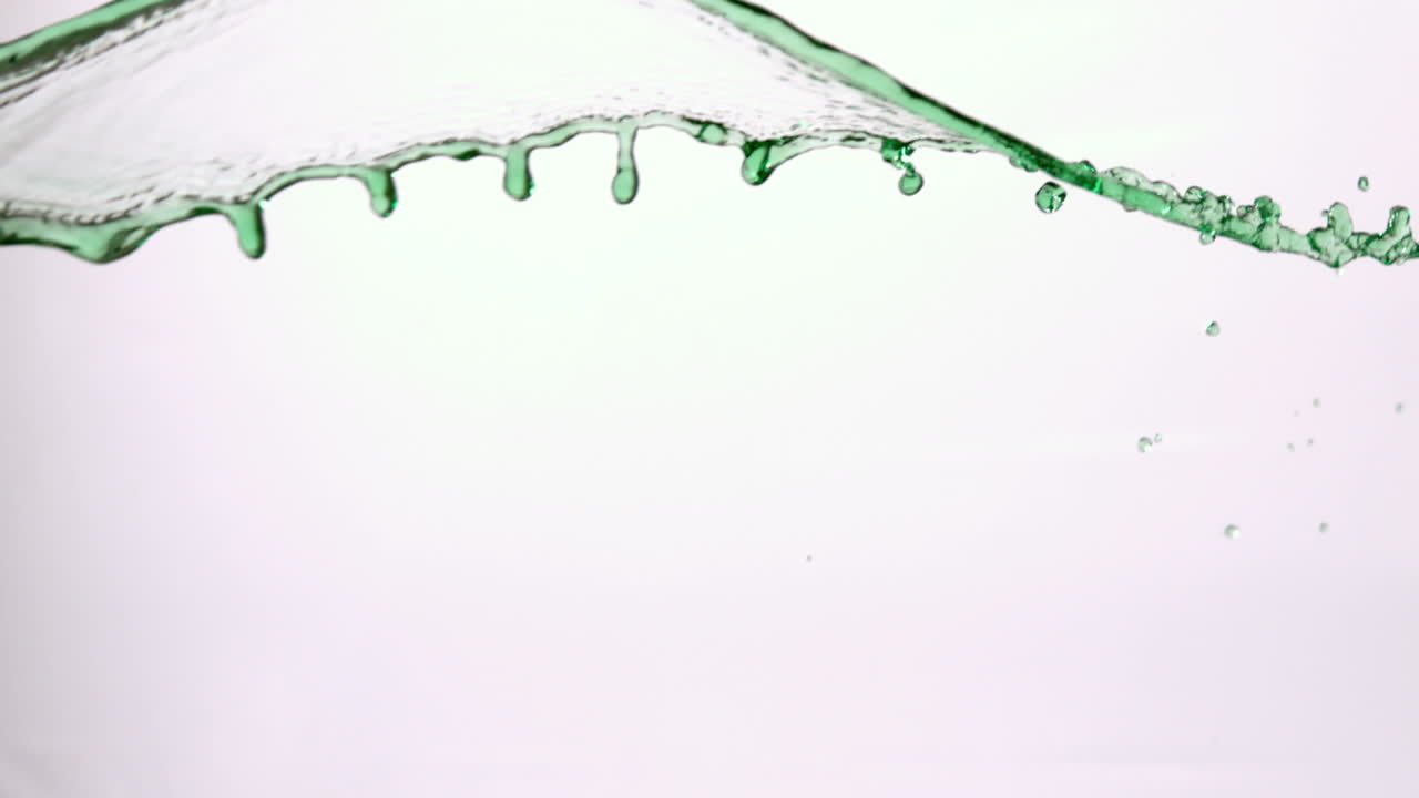 Green water splashing across white background