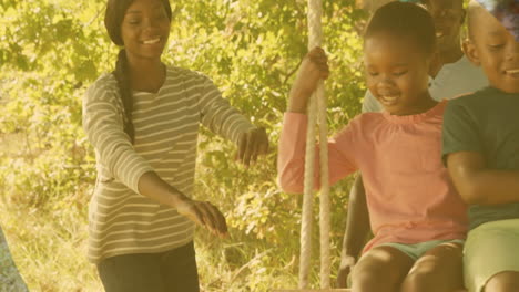animation of african american family smiling in park over leaves
