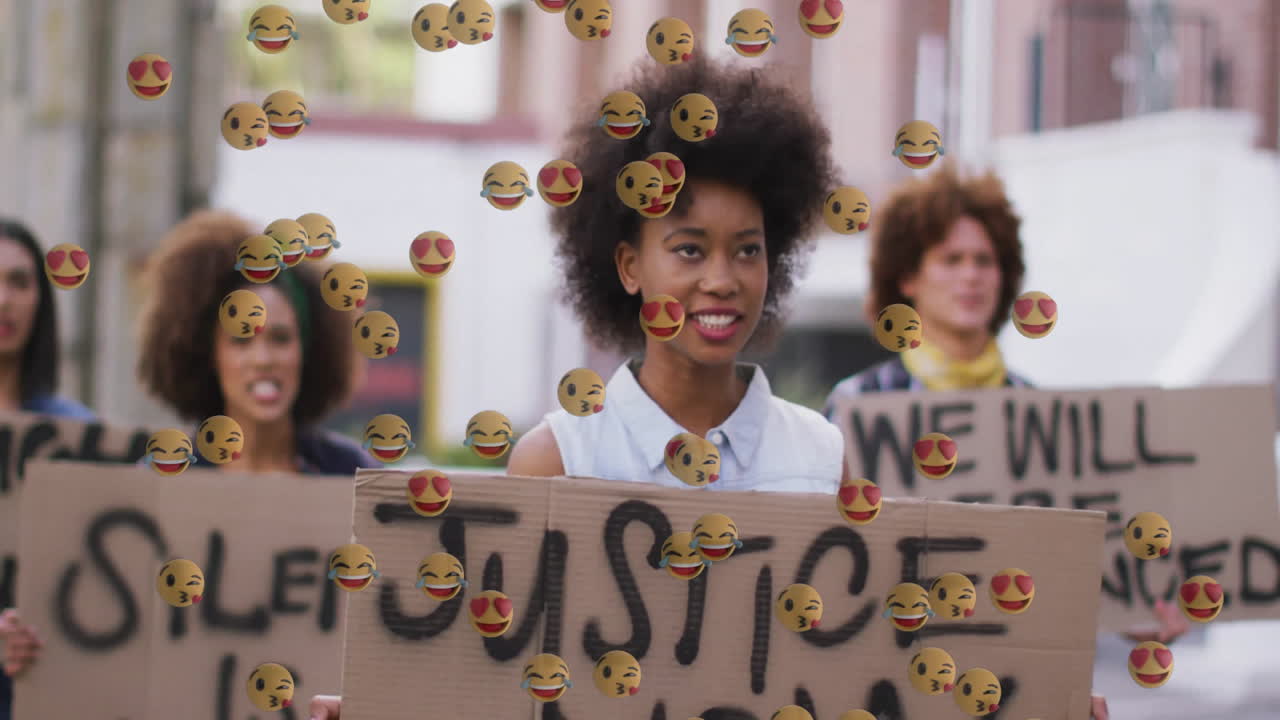 protesters holding justice signs on city sidewalk, floating emojis illustrating technology campaign