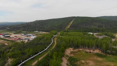 4K-Drone-Video-of-Trans-Alaska-Pipeline-crossing-under-Roadway-in-Fairbanks,-AK-during-Sunny-Summer-Day