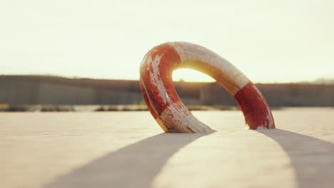 lifebuoy on the city beach at sunset