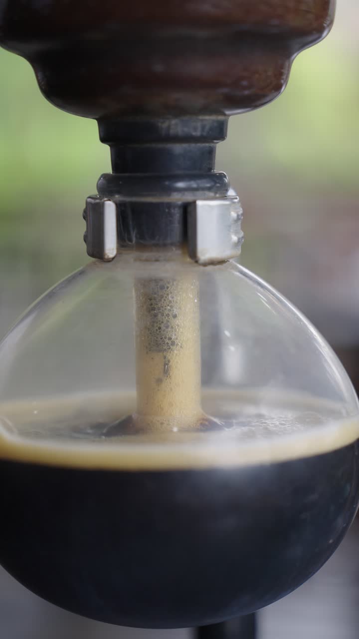 Craft of coffee brewing, machine view, close up vertical