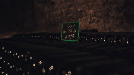 beautiful slow motion shot of a 2019 wine reserve inside a subway cellar in a cave in burgos, spain