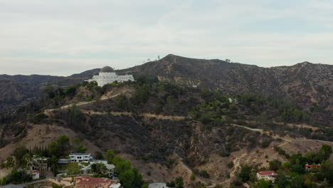 AERIAL:-Griffith-Observatory-with-flight-over-Hollywood-Hills-in-Daylight,-Los-Angeles,-California,-Cloudy