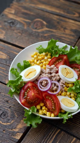 tuna salad with corn, eggs, and tomatoes