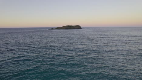 Drone-Flying-Towards-Cook-Island-At-Sunset-In-New-South-Wales,-Australia---aerial-shot