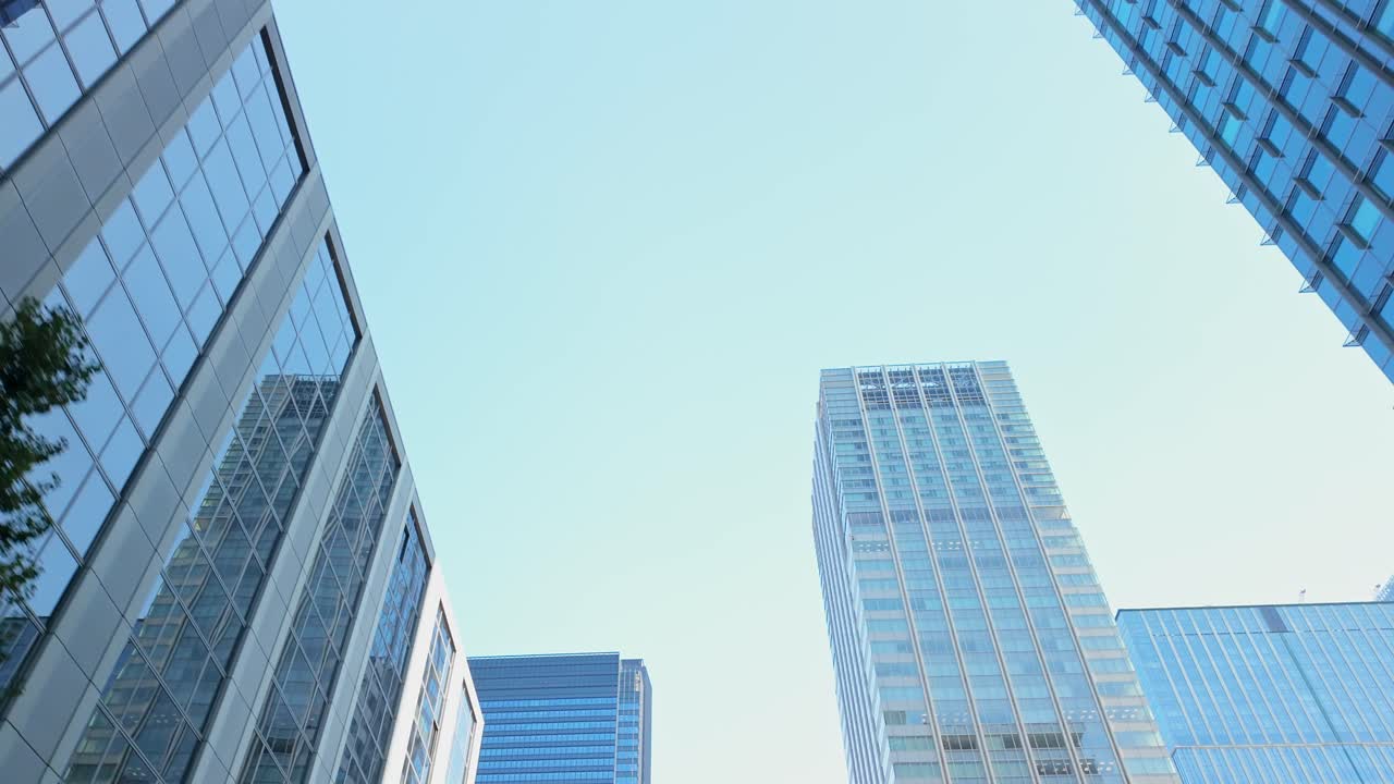 Low-angle shot of Marunouchi Square's impressive skyline, featuring soaring towers and cutting-edge design.
