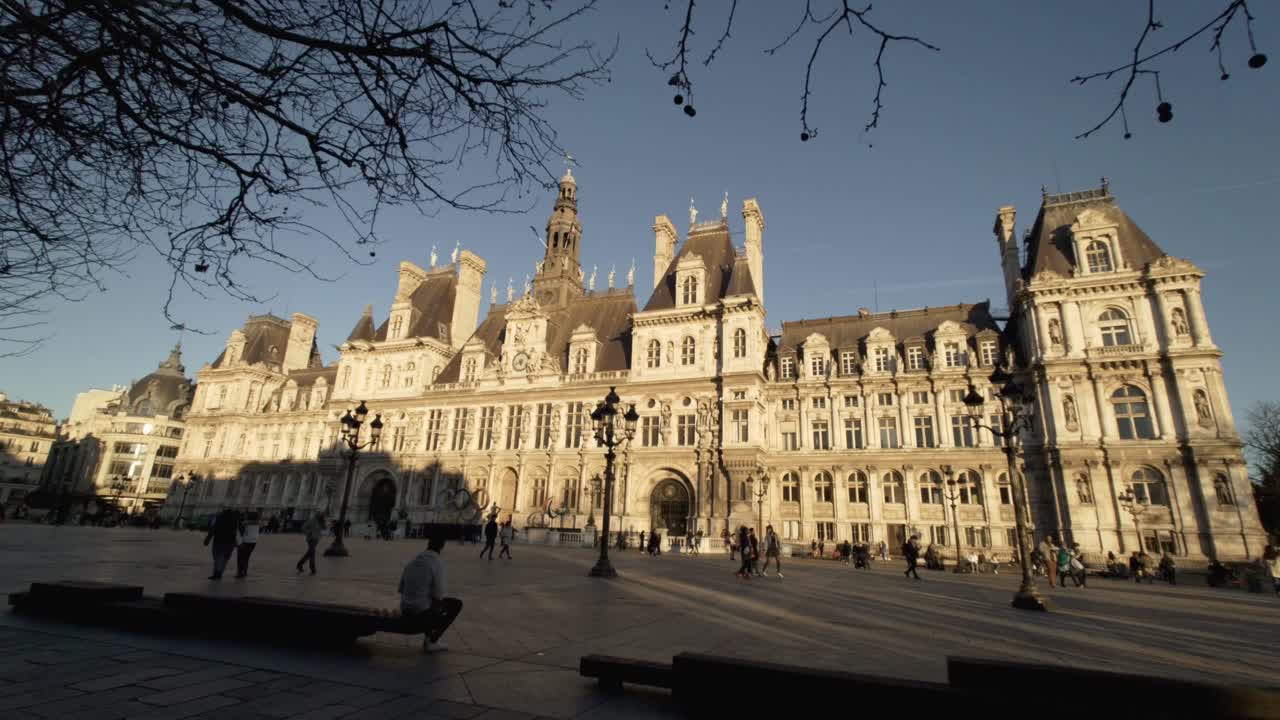 Old French building Hotel de Ville in Paris at the golden hour - panning shot