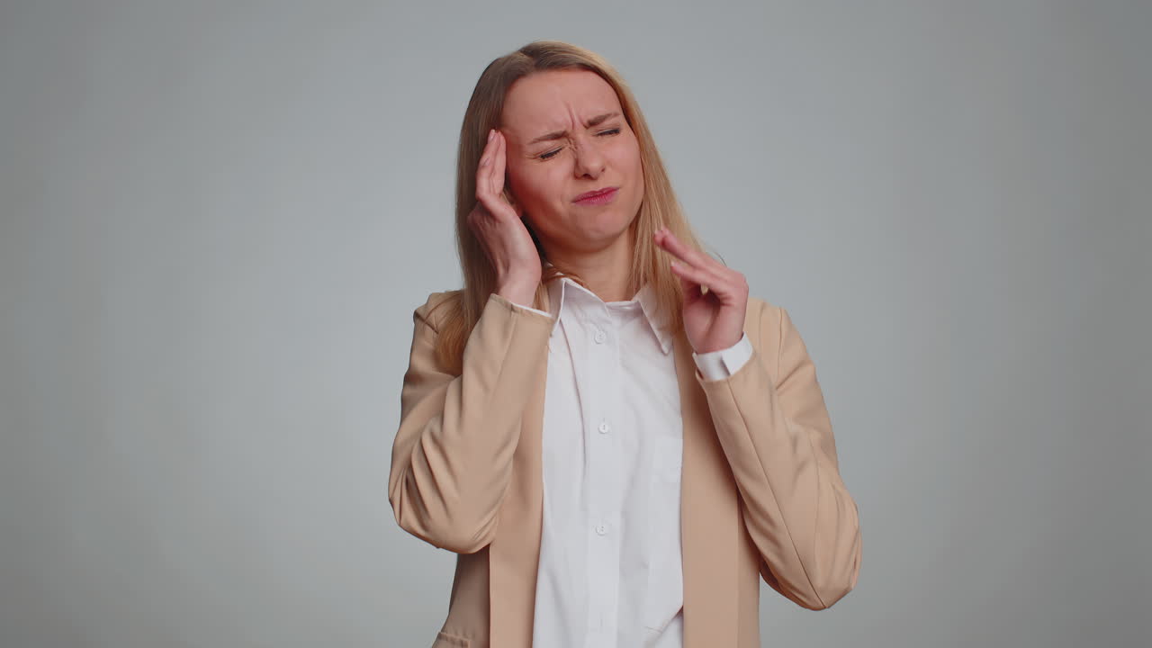 Woman rubbing temples to cure headache problem suffering from tension and migaine stress pain