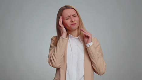 woman rubbing temples to cure headache problem suffering from tension and migaine stress pain