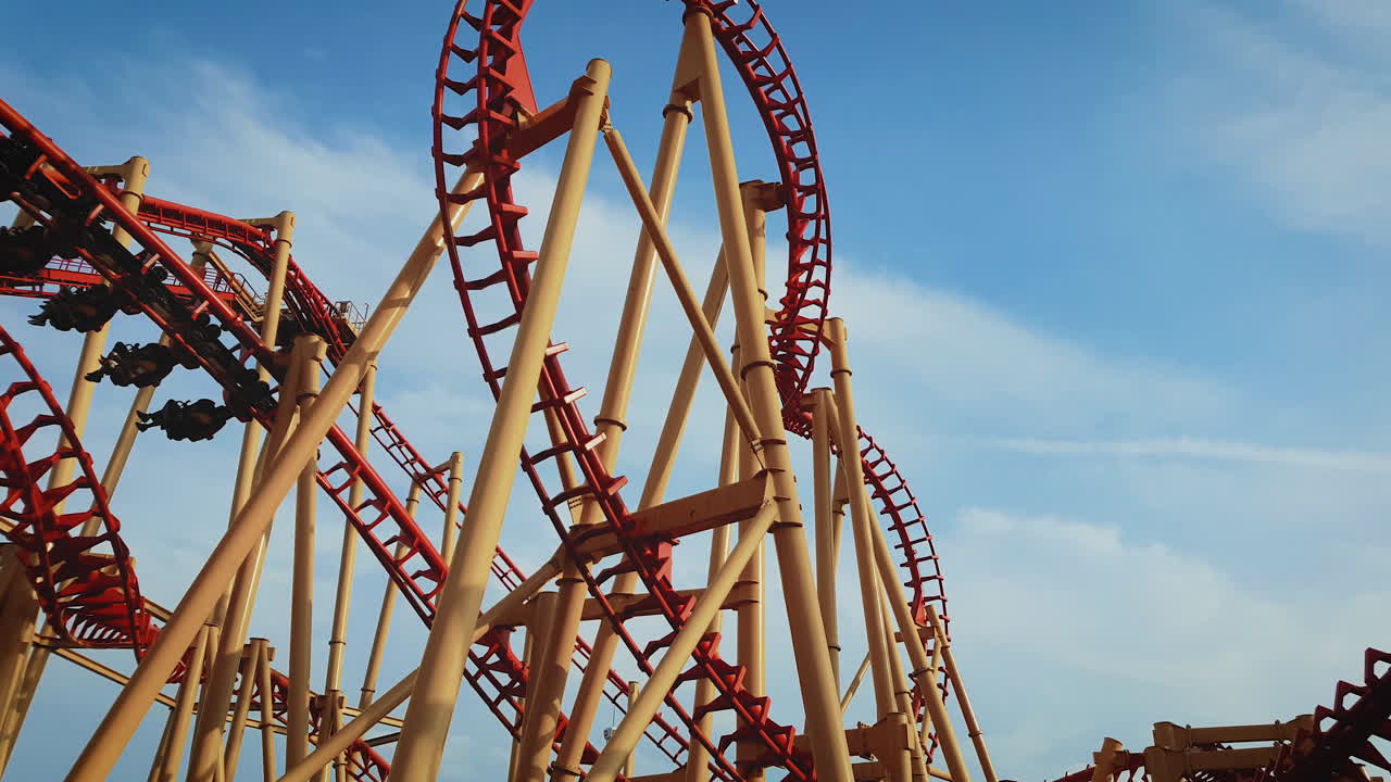 People riding the twists and turns of a roller coaster in a theme park