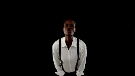 androgynous man posing against black background