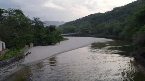 aerial view towards a beach at the rio sahy river, evening in sao sebastiao, brazil