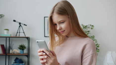 teenage girl using smartphone at home