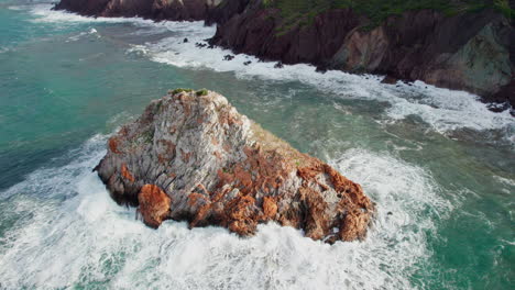 scoglio il morto, sardinia, iglesias: fantastic aerial view of the famous rock on the island of sardinia