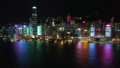 aerial drone hong kong island central financial district, victoria harbour at night