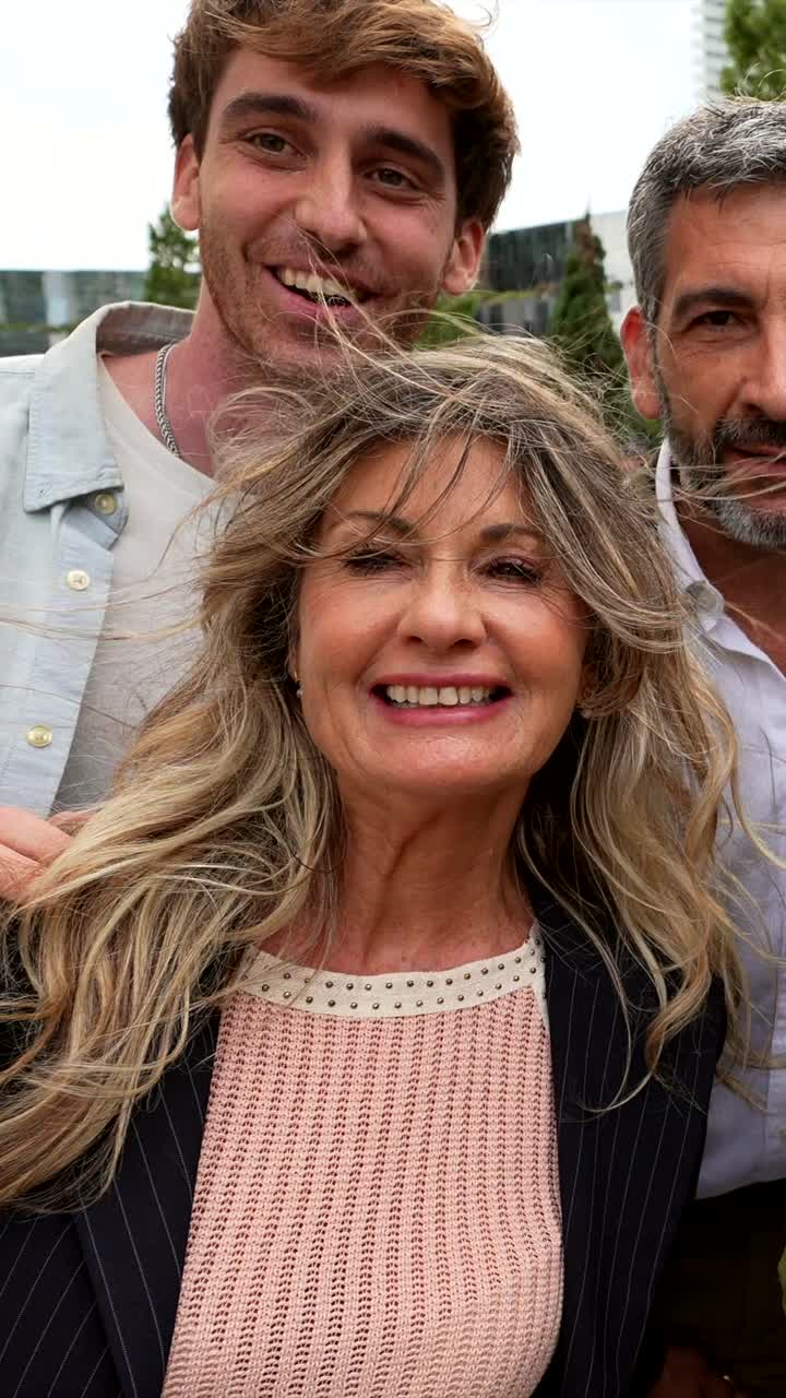 Group of smiling people taking a selfie