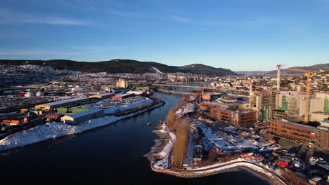 aerial drone view of port of drammen and large construction area separated by the river in a clear winter day