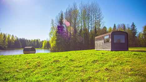 timelapse of a green meadow with flowers, trees and a wooden cabin, over which time pass at high speed