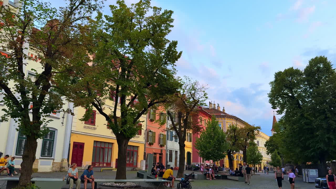Sibiu, Romania, 1 July 2025: Historic Buildings and Trees in Sibiu. Charming colorful buildings and trees in Sibiu, Romania, capturing the old town’s cultural and architectural beauty